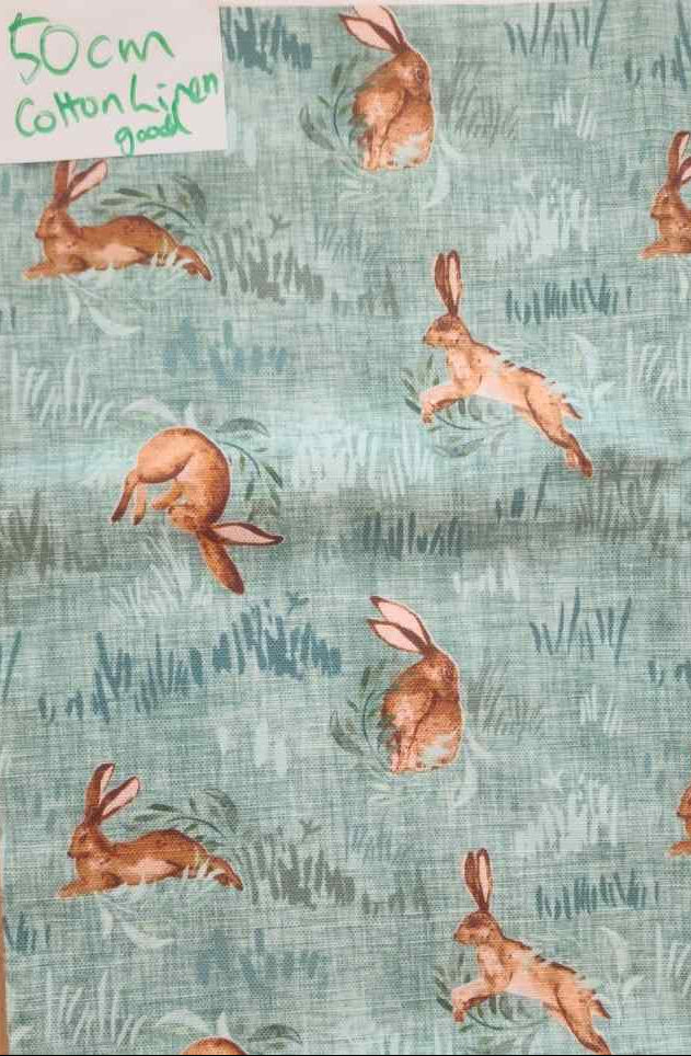 Fabric with rabbit pattern on a green background