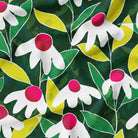 Print-on-demand 'Evening Directional Daisy' fabric showcasing bold daisies on a lush green background, available in various textiles